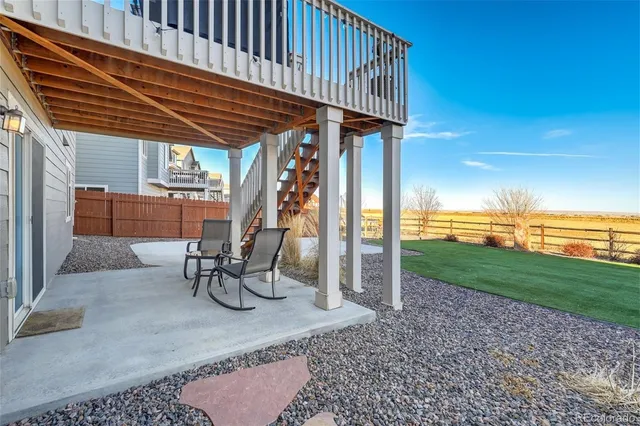 a patio with a table and chairs