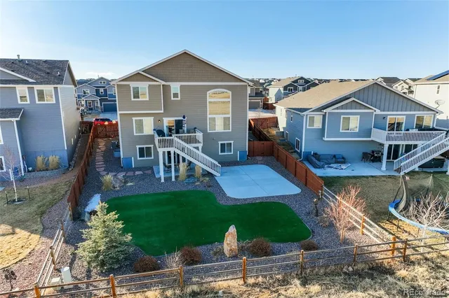a front view of a house with a yard table and chairs