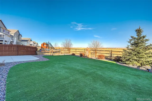 a view of a lake with lawn chairs