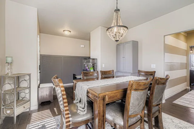a view of a dining room with furniture wooden floor and a chandelier