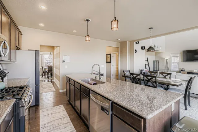 a kitchen with counter top space and living room