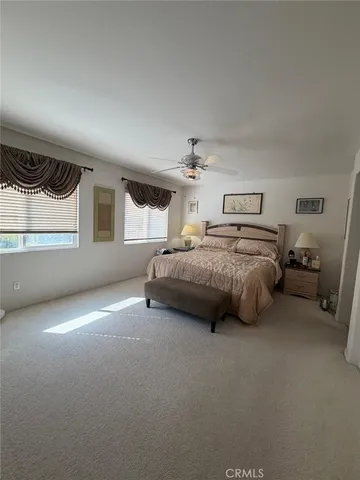 a spacious bedroom with a bed and a cabinets