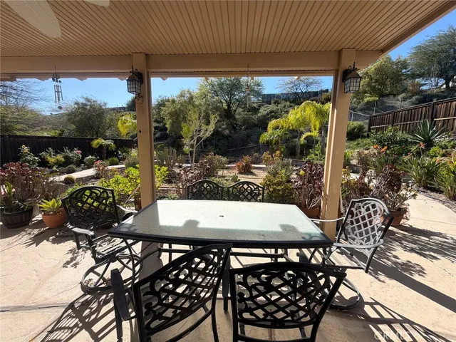 a view of a patio with table and chairs and potted plants
