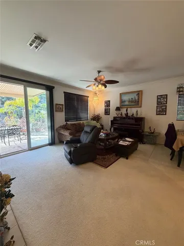 a bed room with furniture window and a flat screen tv