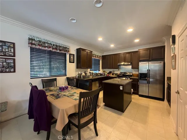 a kitchen with a refrigerator and a wooden cabinets