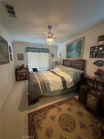 a bedroom with a bed a couch and dresser