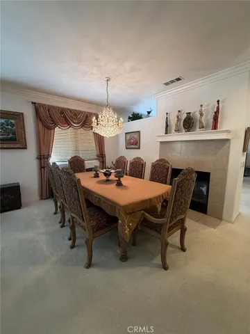 a dining room with furniture and chandelier