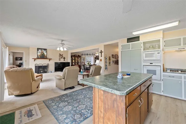 a living room with fireplace furniture and a table