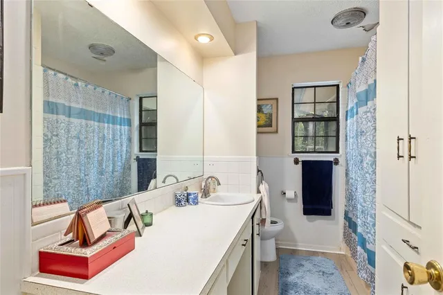 a bathroom with a tub sink and mirror