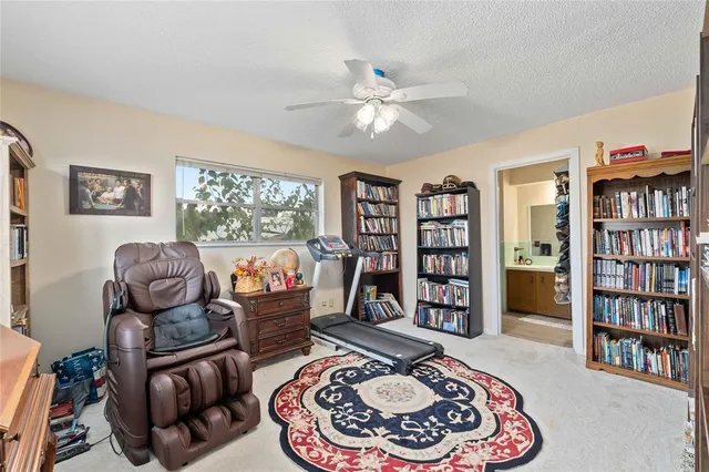 a living room with fireplace furniture and a book shelf