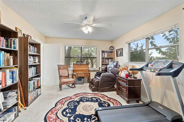 a room with furniture a bookshelf and a window