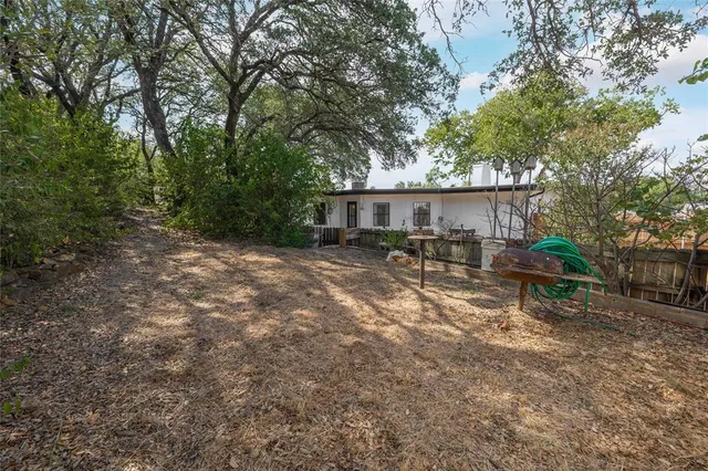 a backyard of a house with table and chairs