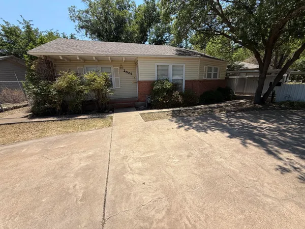 a backyard of a house with plants and trees