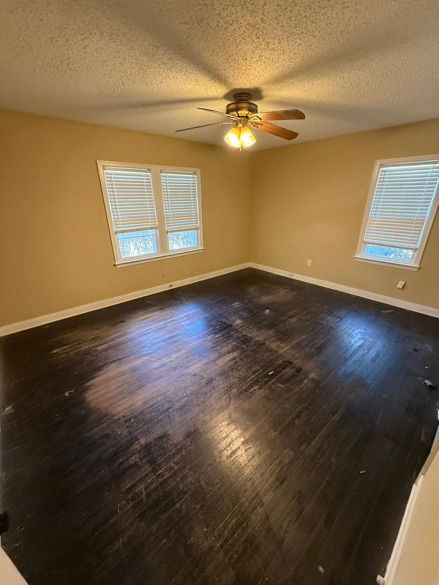 2805 27th Street Lubbock, TX 79410 - Photo 3 of 11 a view of a livingroom with wooden floor and a ceiling fan