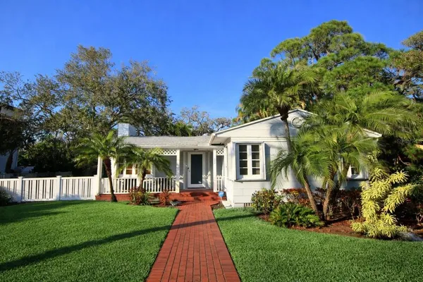 a front view of a house with a yard table and chairs