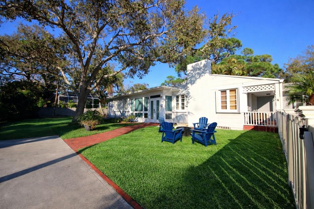 220 Lyndhurst Street Dunedin, FL 34698 - Photo 2 of 20 a view of a house with backyard porch and sitting area