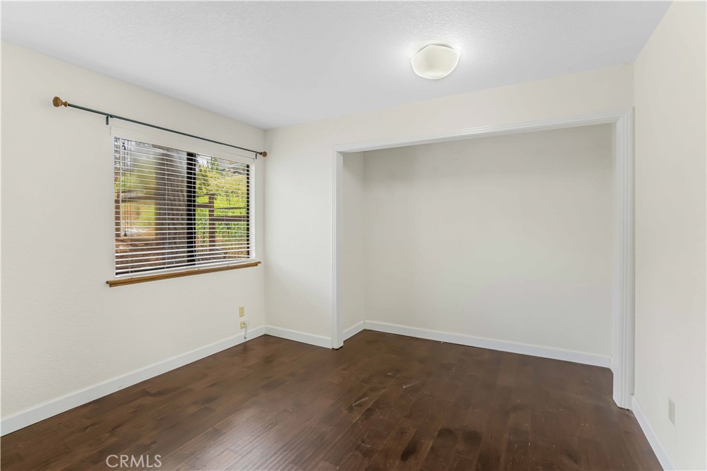 2755 Taft Place Cambria, CA 93428 - Photo 19 of 43 an empty room with wooden floor and windows