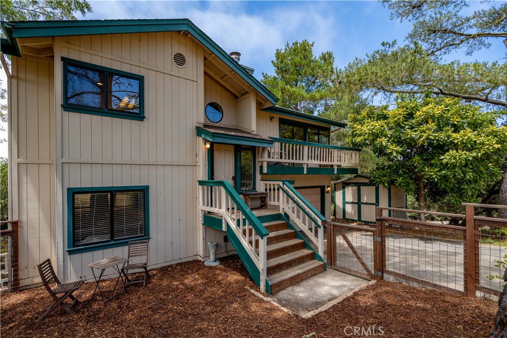 2755 Taft Place Cambria, CA 93428 - Photo 2 of 43 a front view of a house with wooden stairs and a bench