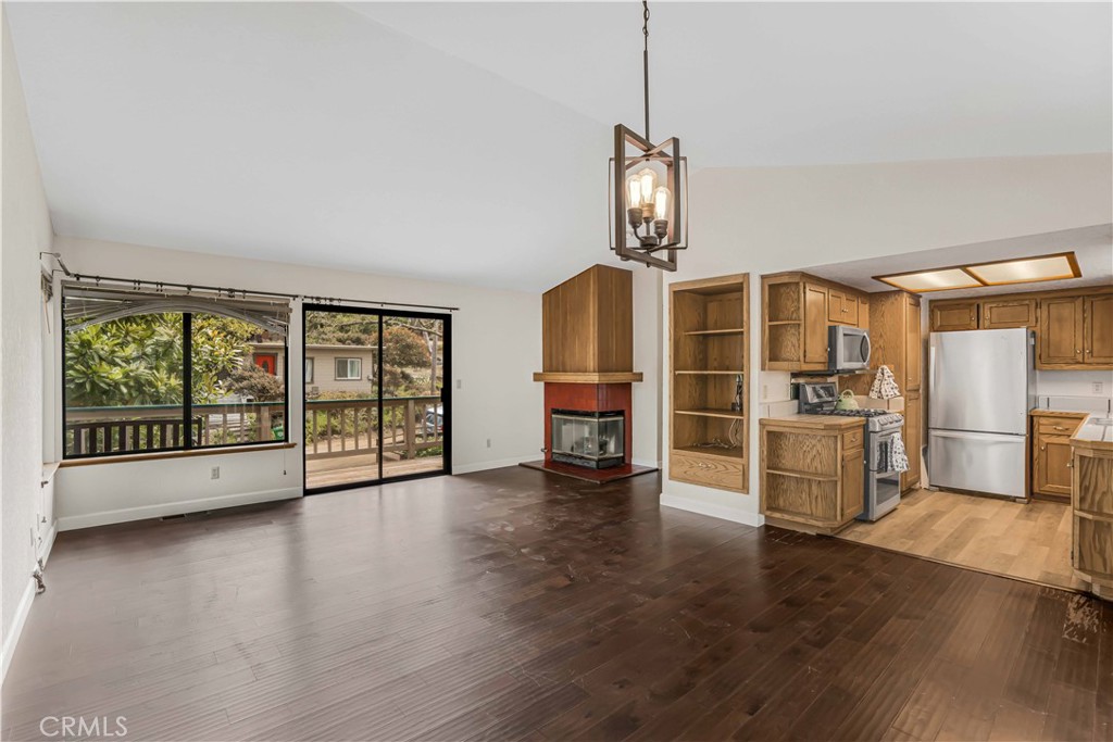 2755 Taft Place Cambria, CA 93428 - Photo 8 of 43 a view of a big room with wooden floor fire place and windows