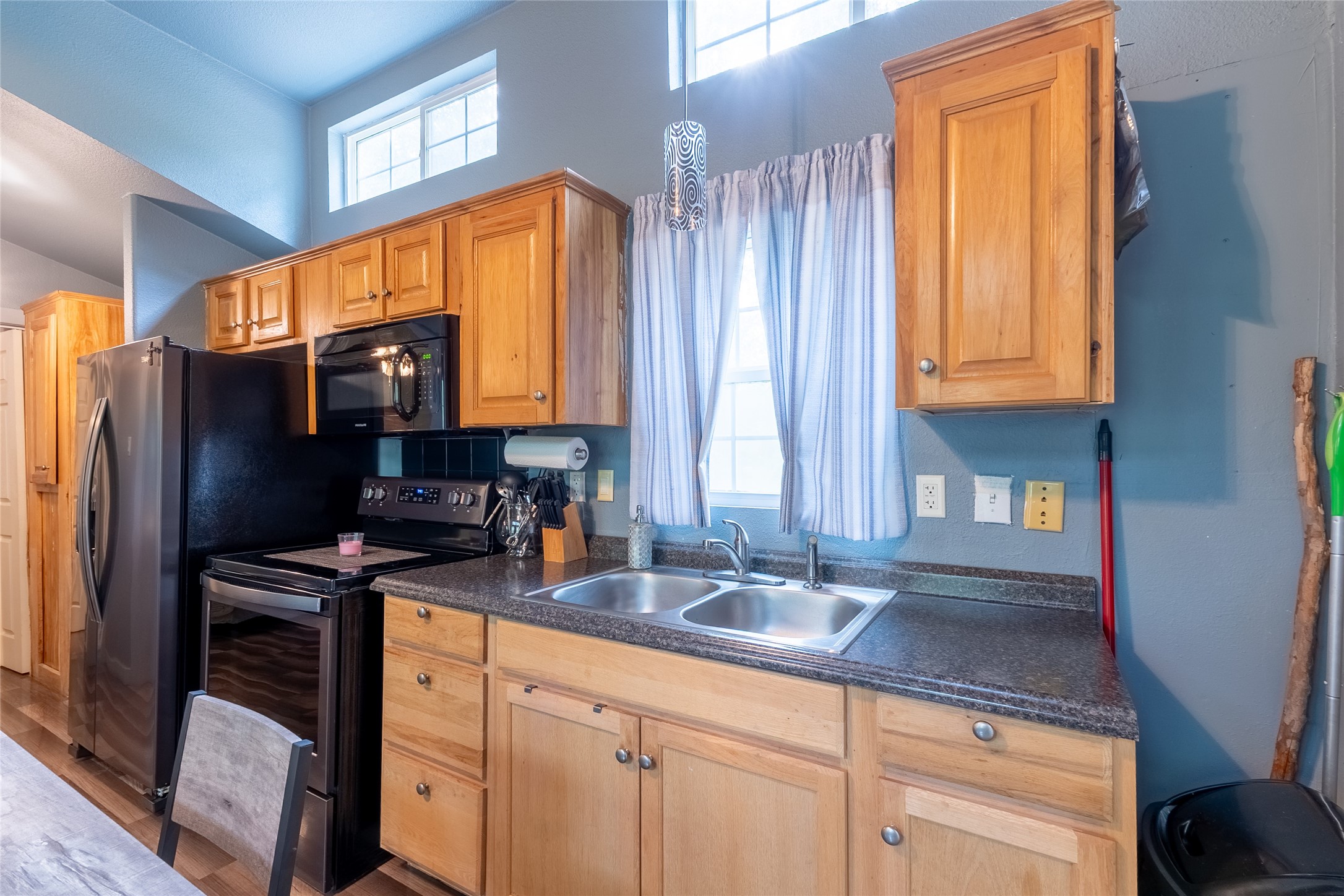 215 Center Street Cleveland, TX 77327 - Photo 14 of 38 a kitchen with stainless steel appliances a sink cabinets and a window