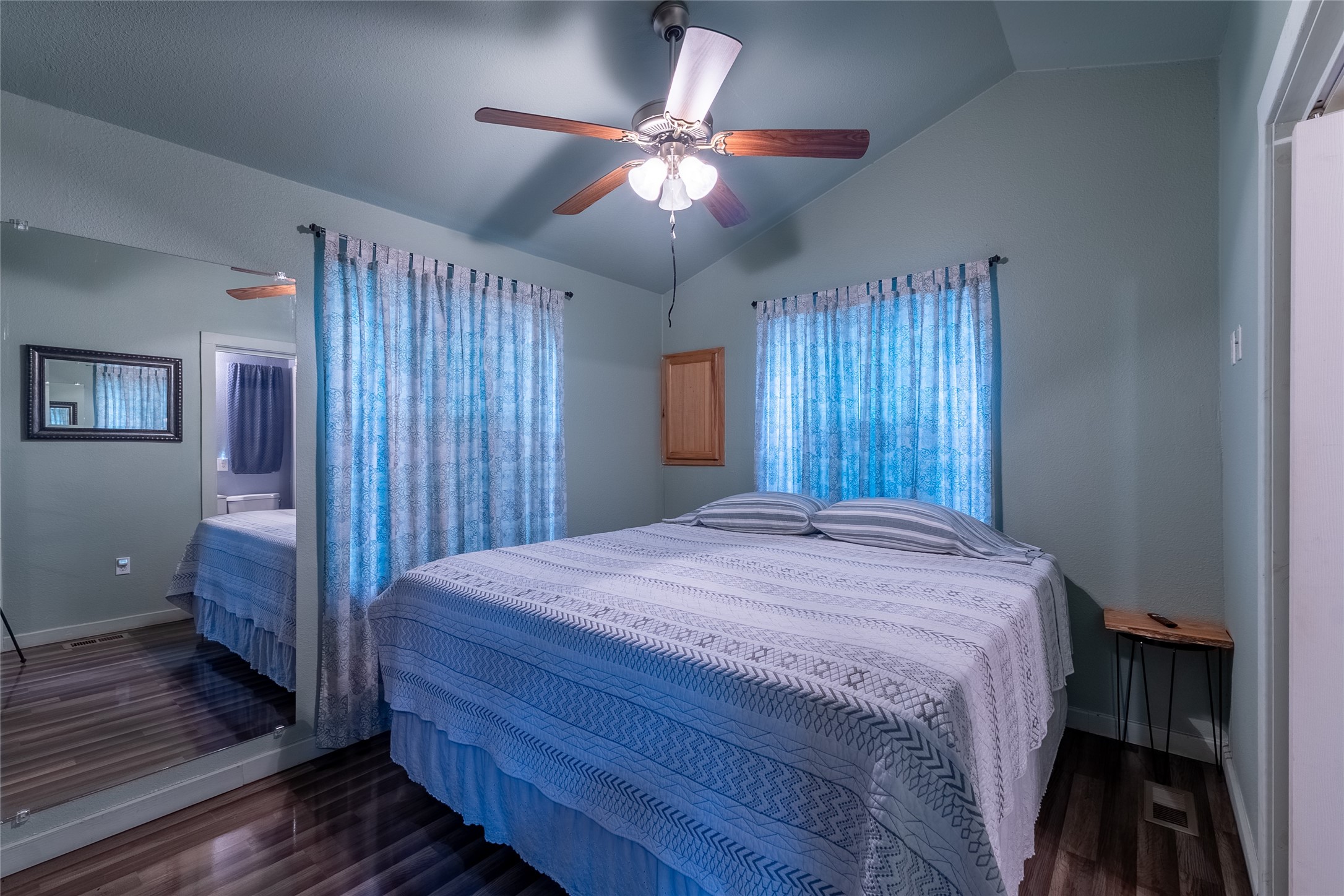 215 Center Street Cleveland, TX 77327 - Photo 17 of 38 a bedroom with a bed and a chandelier