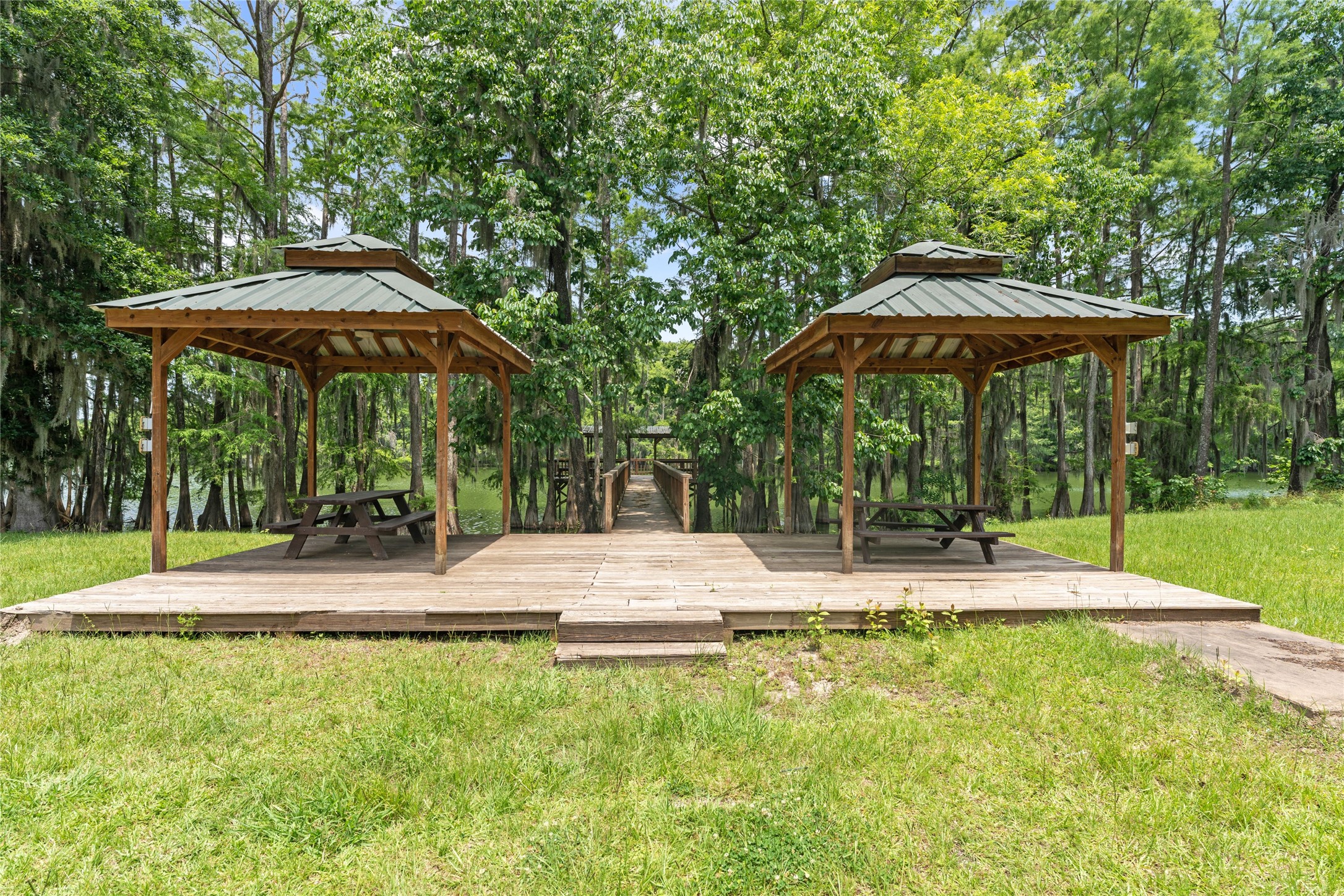 215 Center Street Cleveland, TX 77327 - Photo 25 of 38 a view of patio with chairs and umbrella