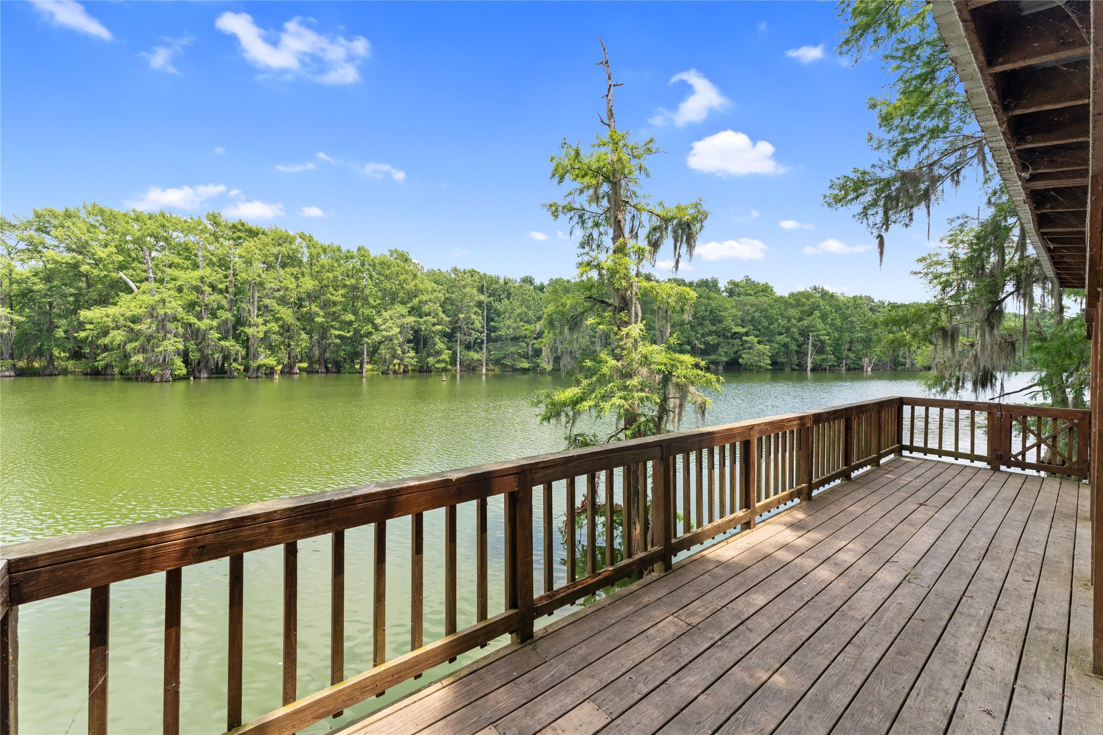 215 Center Street Cleveland, TX 77327 - Photo 28 of 38 a view of balcony with wooden floor and lake view