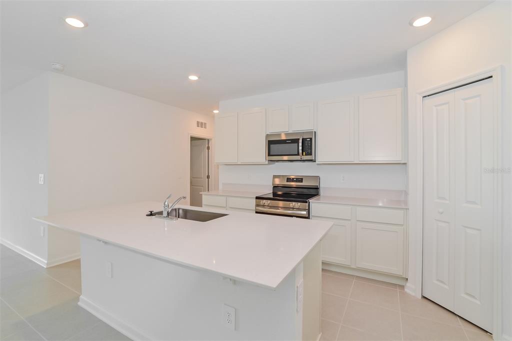2708 Lookout Rdg Road Haines City, FL 33844 - Photo 3 of 15 a kitchen with appliances a sink and cabinets