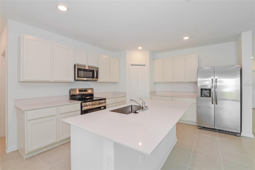2708 Lookout Rdg Road Haines City, FL 33844 - Photo 7 of 15 a kitchen that has a sink cabinets and stainless steel appliances