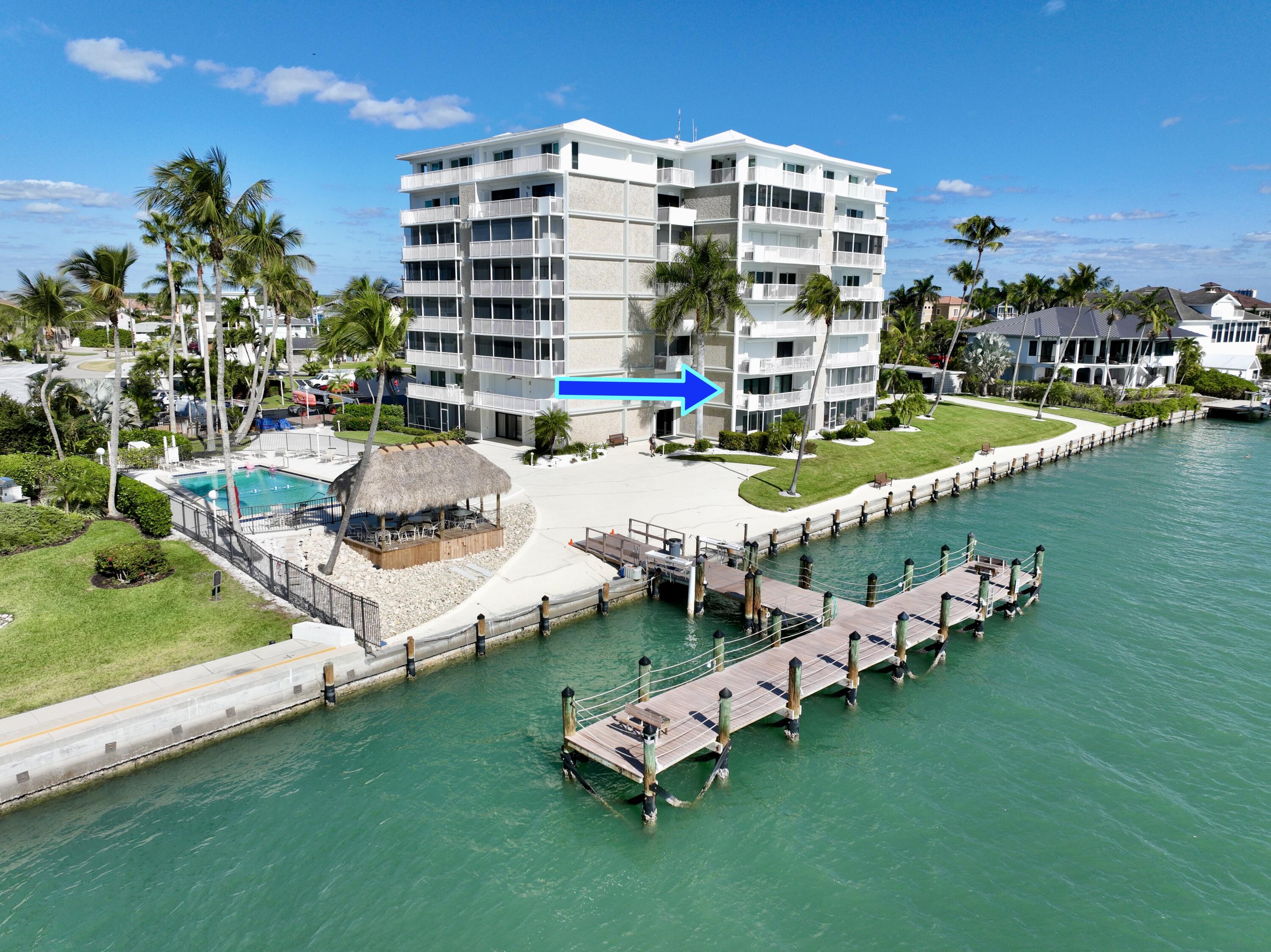 60 West Pelican Street, Unit 206 Naples, FL 34113 - Photo 20 of 29 a multi story pool table and chairs with the ocean view
