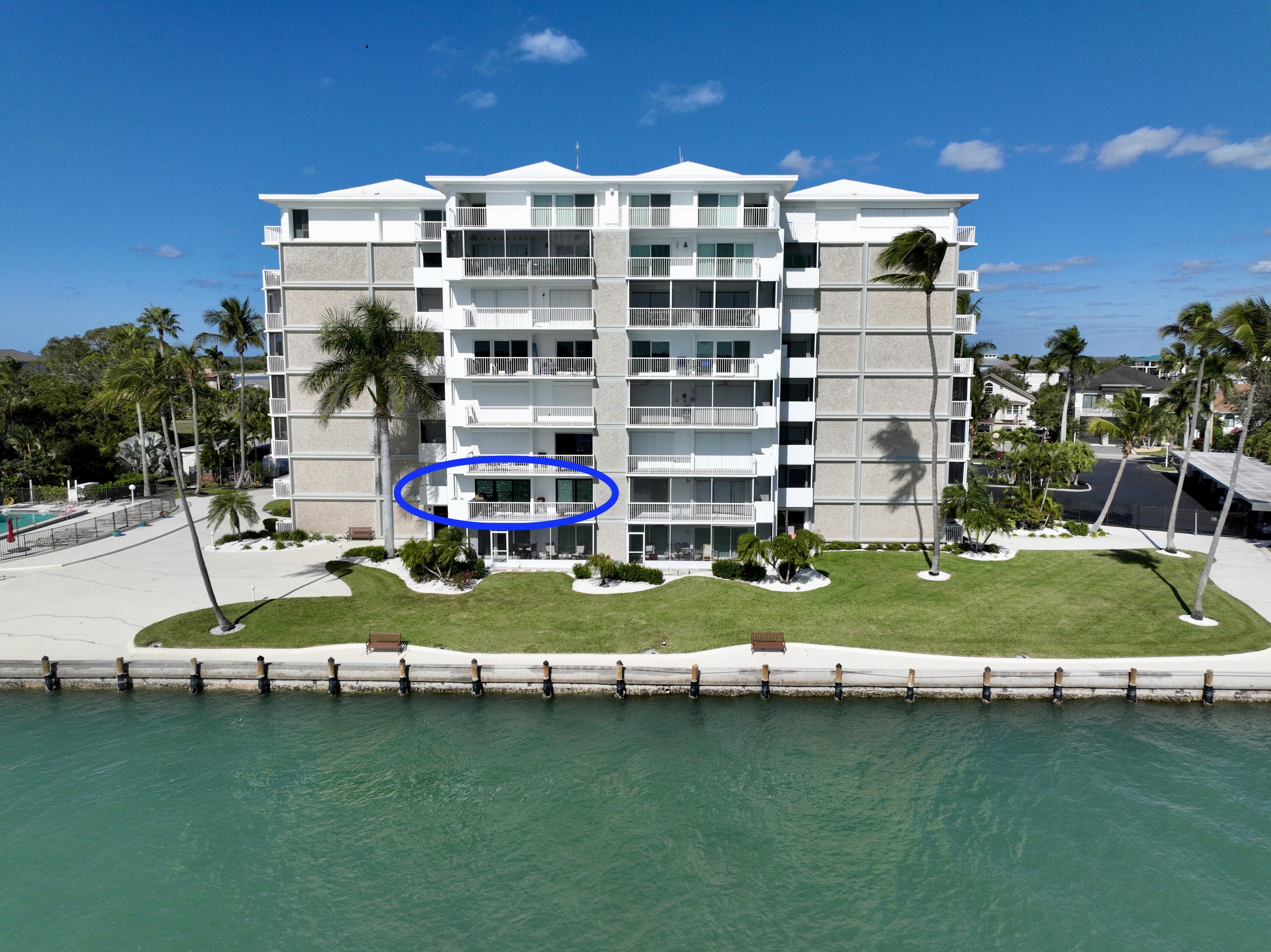60 West Pelican Street, Unit 206 Naples, FL 34113 - Photo 2 of 29 a view of a building with a swimming pool