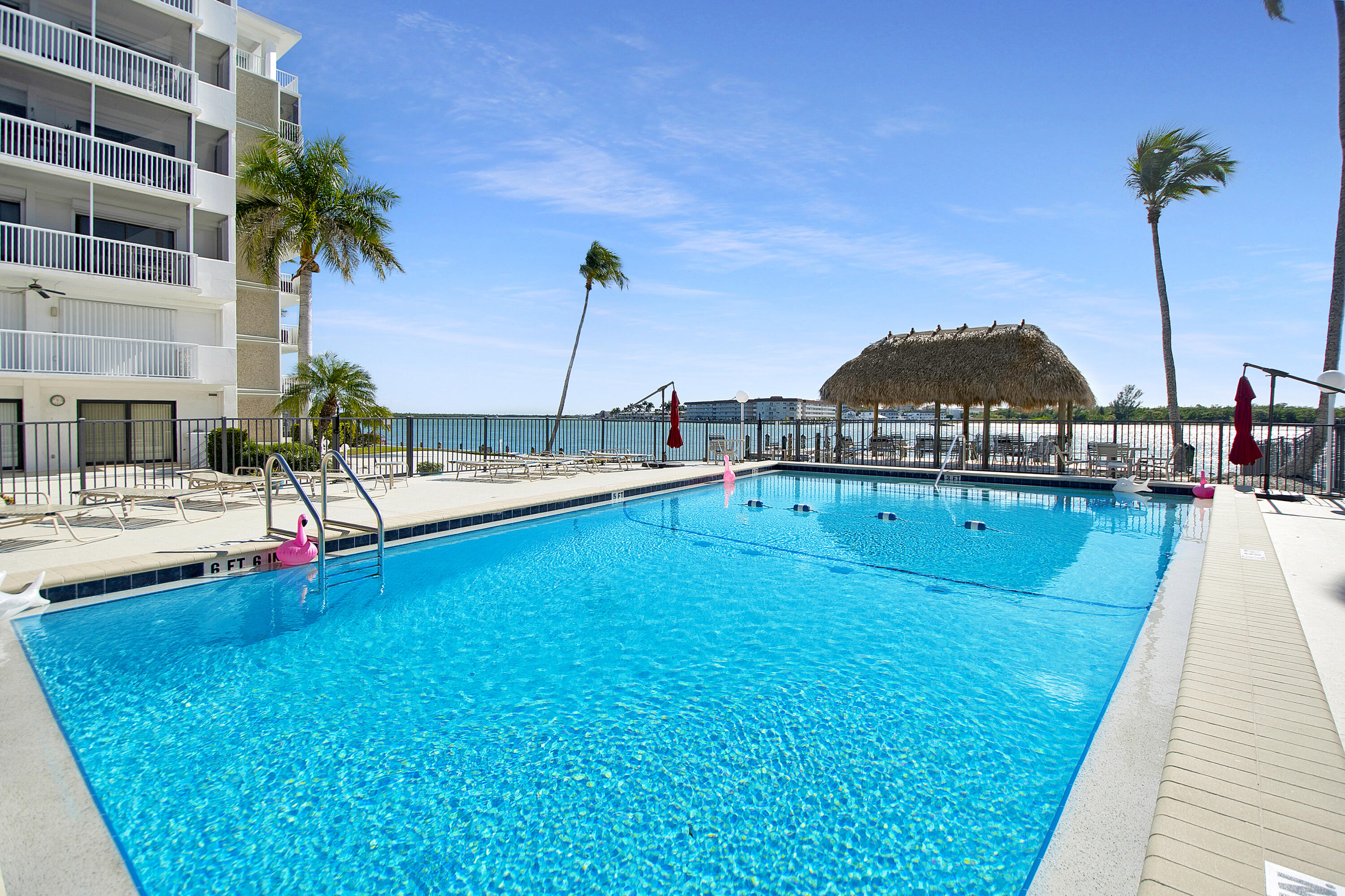 60 West Pelican Street, Unit 206 Naples, FL 34113 - Photo 23 of 29 a view of swimming pool with a table and chairs