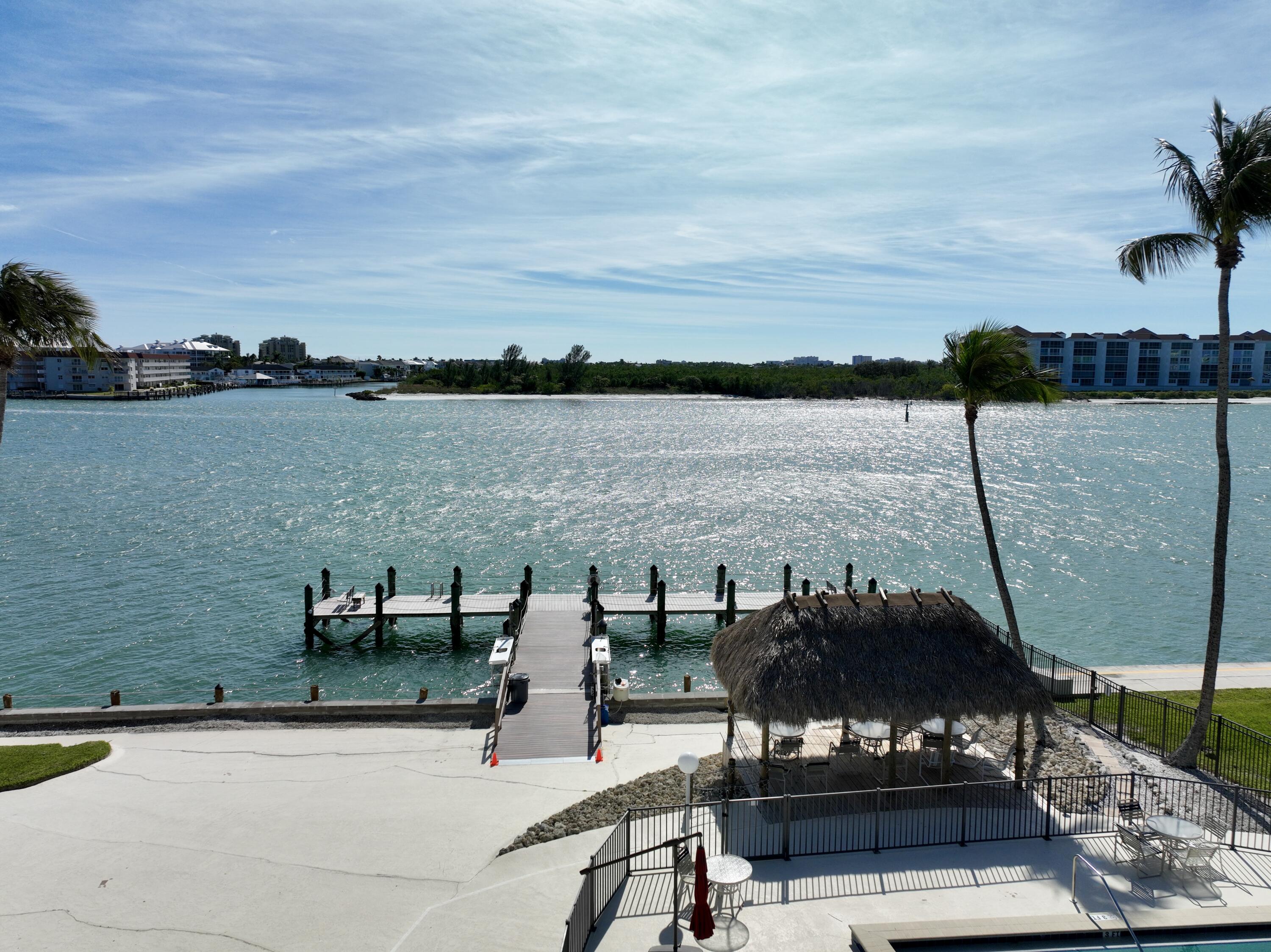 60 West Pelican Street, Unit 206 Naples, FL 34113 - Photo 28 of 29 a view of a lake from a terrace