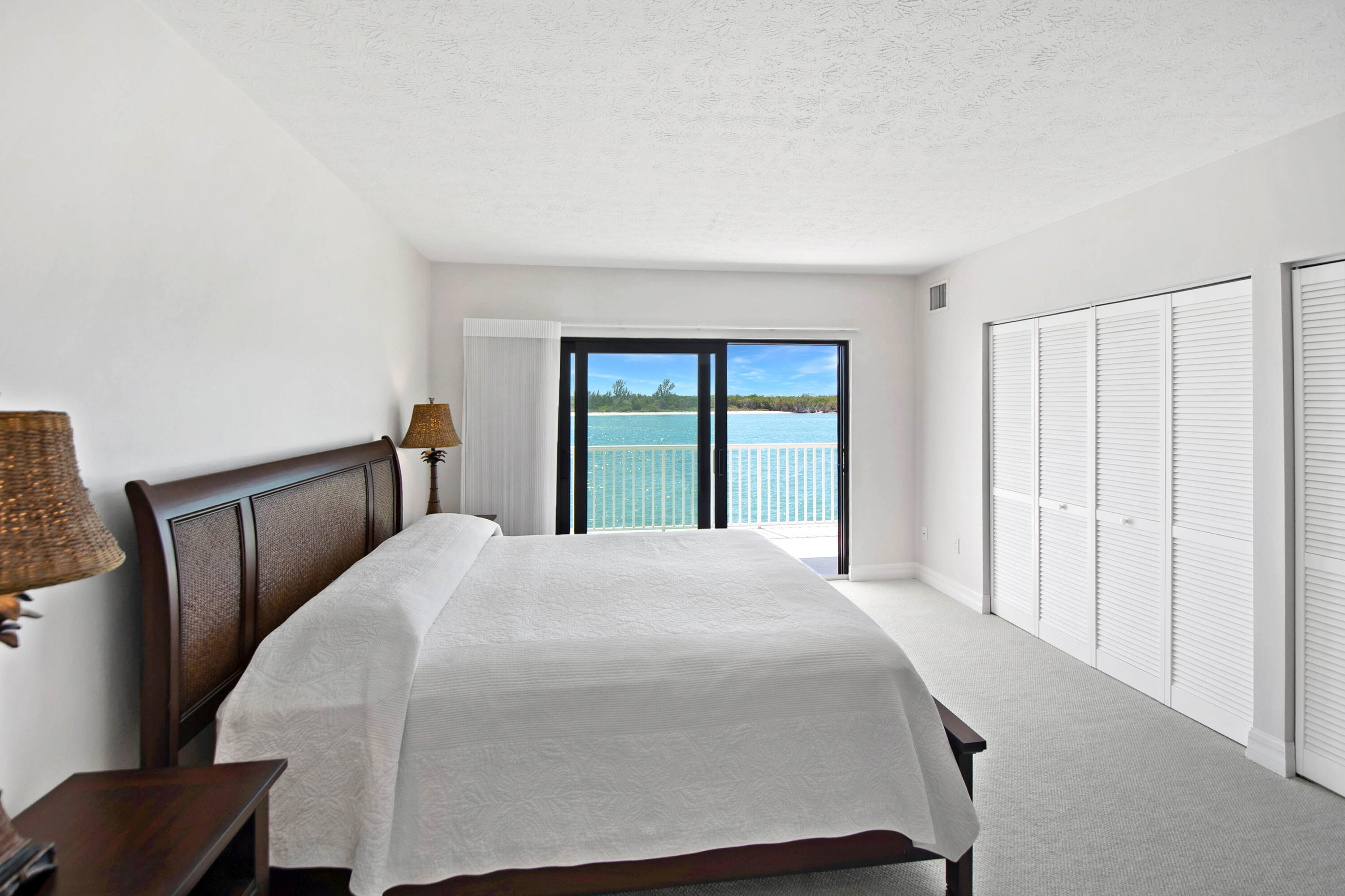 60 West Pelican Street, Unit 206 Naples, FL 34113 - Photo 9 of 29 a bedroom with a large bed and a window