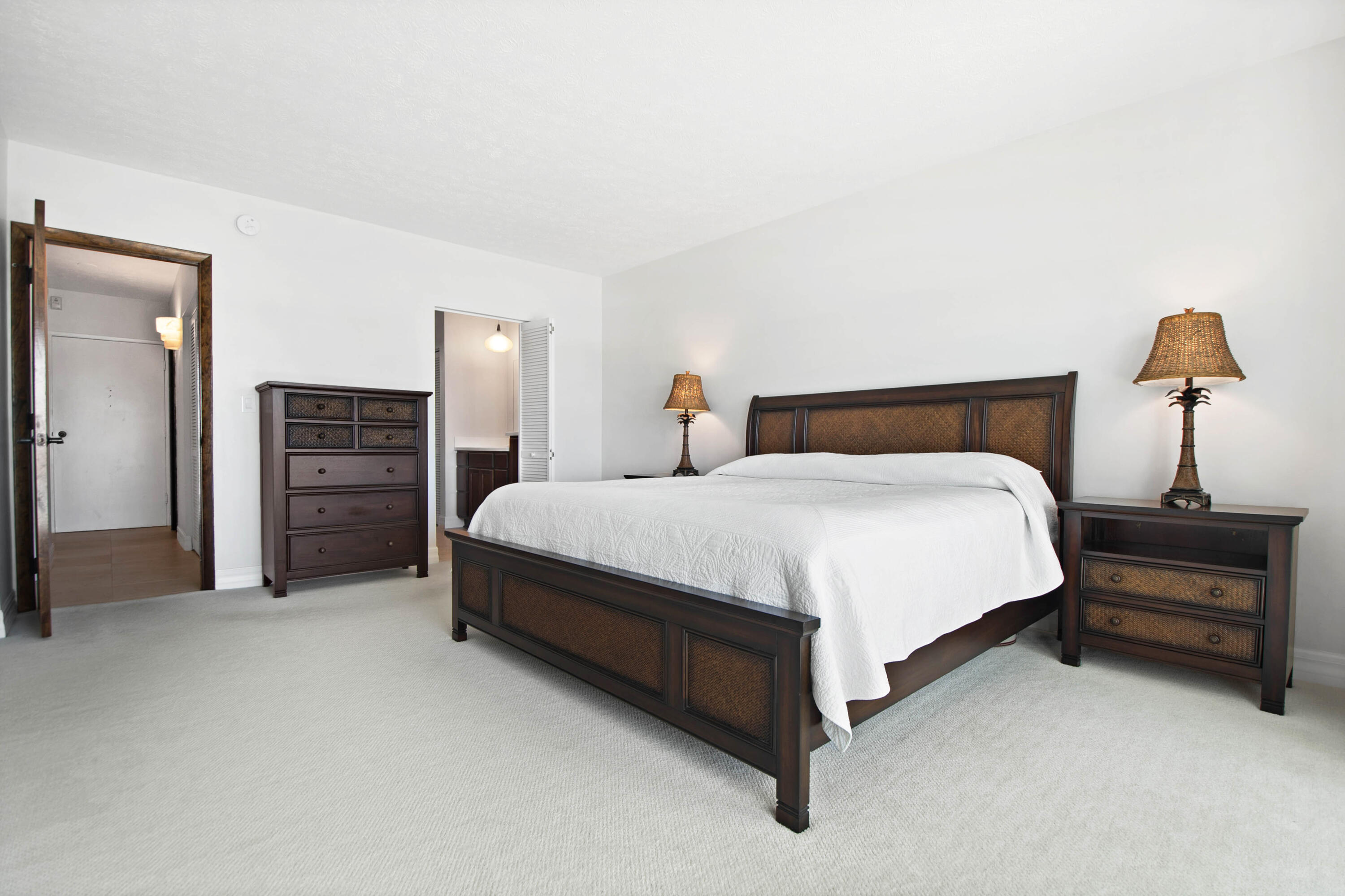 60 West Pelican Street, Unit 206 Naples, FL 34113 - Photo 10 of 29 a spacious bedroom with a bed and walk in closet