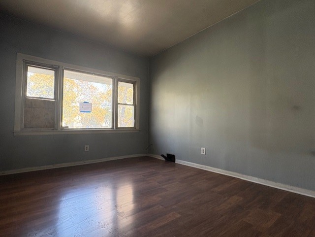 251 West 105th Place Chicago, IL 60628 - Photo 2 of 13 an empty room with wooden floor and windows