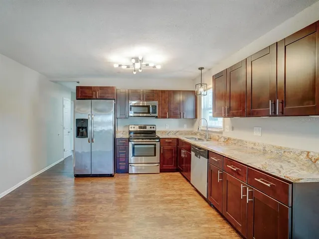 a large kitchen with cabinets and stainless steel appliances
