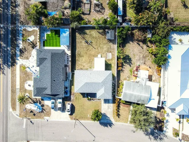 an aerial view of a house with sitting area and garden