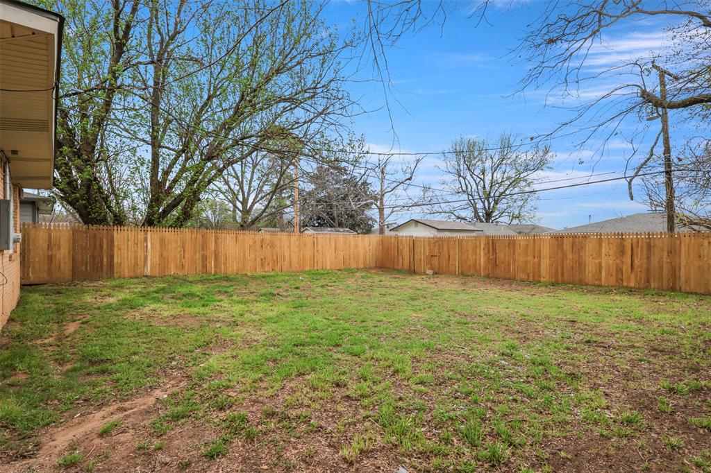 732 Bullock Street Denison, TX 75020 - Photo 22 of 29 a view of a backyard with green space