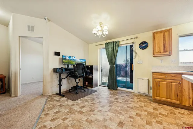 a bedroom with a balcony a bed and a chandelier