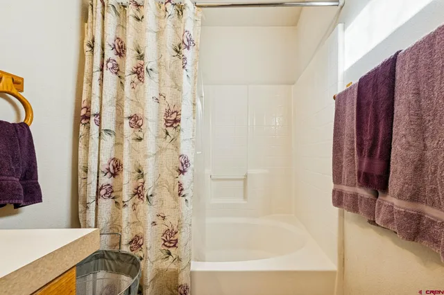 a bathroom with a granite countertop toilet sink and mirror