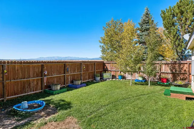 a view of a backyard with sitting area