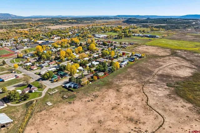 aerial view of a house with a yard