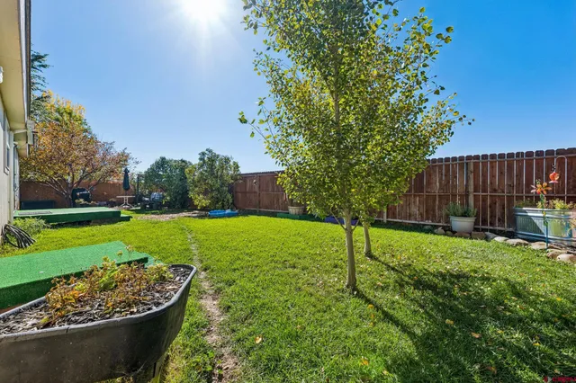 a view of a backyard with wooden fence