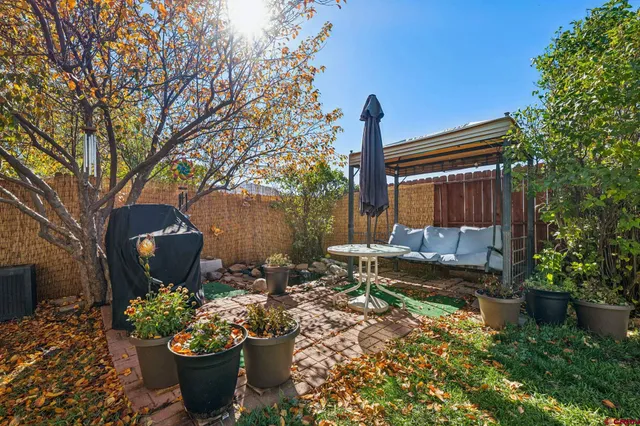 a front view of a house with a yard and fountain