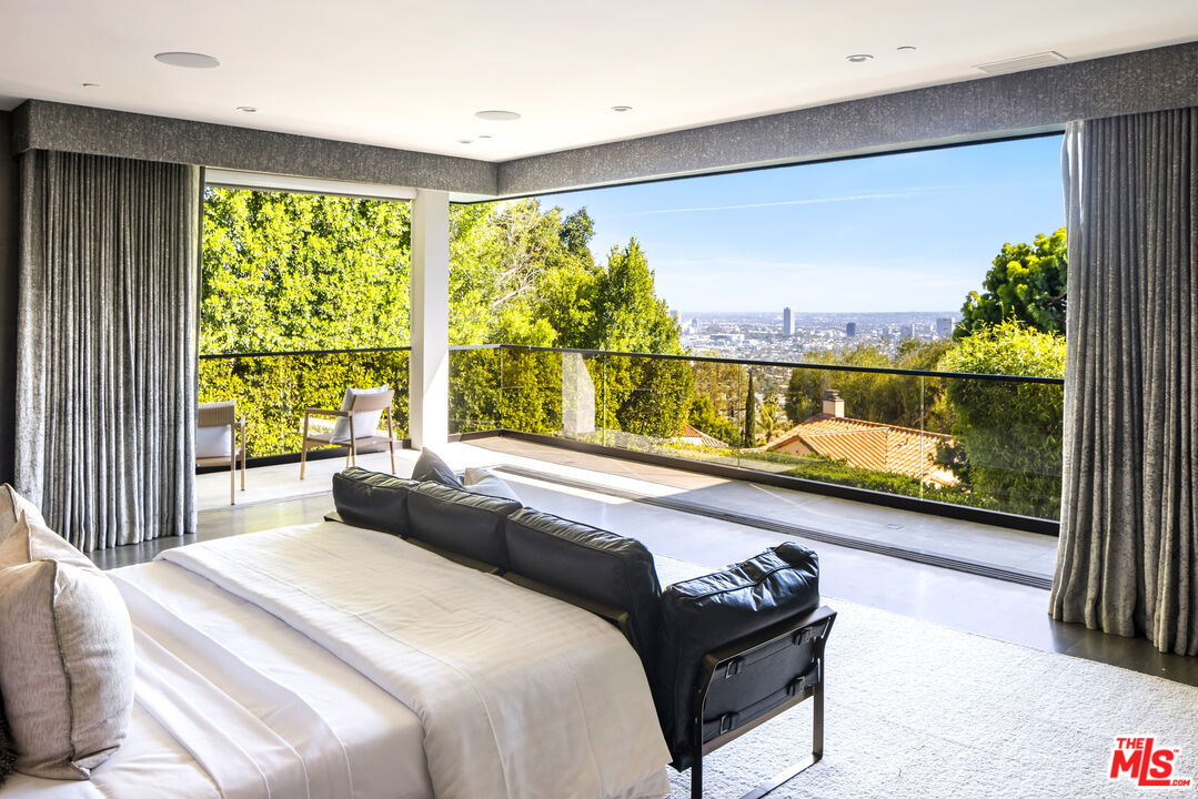 1516 North Kings Road Los Angeles, CA 90069 - Photo 17 of 45 a bedroom with a bed and large window