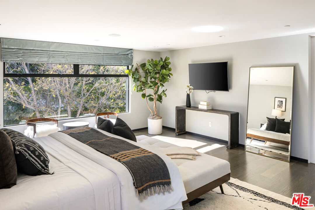 1516 North Kings Road Los Angeles, CA 90069 - Photo 28 of 45 a bedroom with a bed and large window