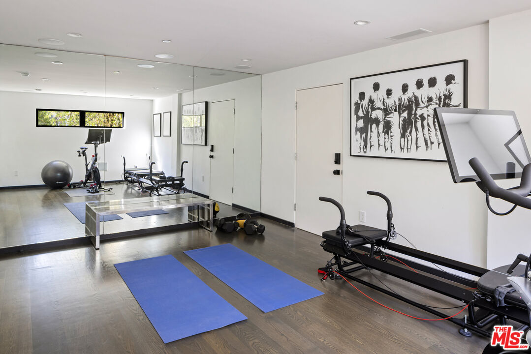 1516 North Kings Road Los Angeles, CA 90069 - Photo 30 of 45 a room with gym equipment and a large window