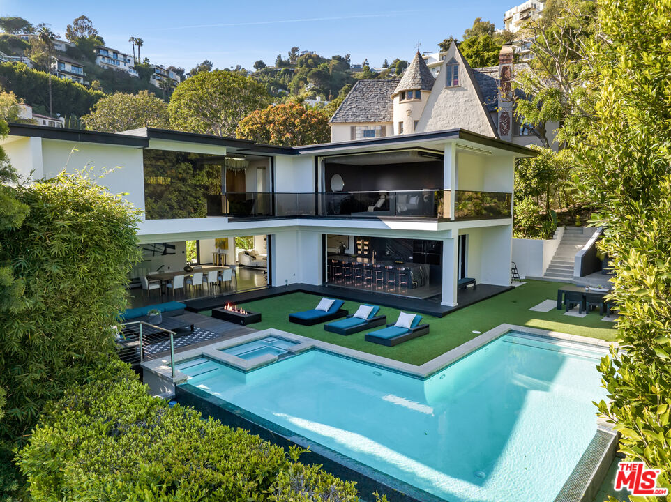 1516 North Kings Road Los Angeles, CA 90069 - Photo 33 of 45 a view of an house with backyard space and balcony