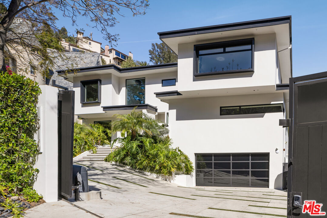 1516 North Kings Road Los Angeles, CA 90069 - Photo 34 of 45 a front view of a house with a yard